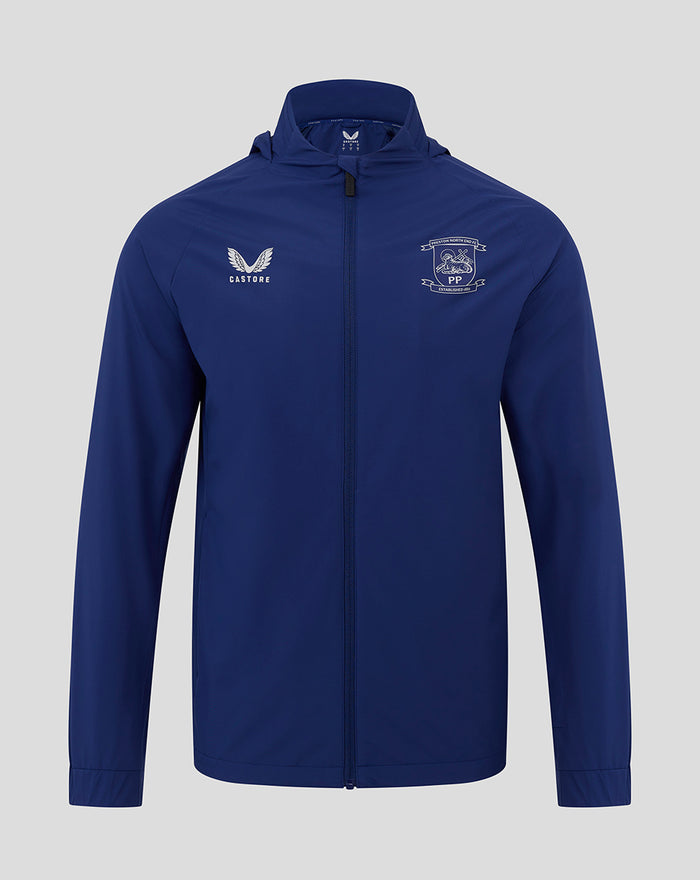 Front view of blue packable hood shower jacket with zip featuring the club crest and Castore logo on the chest