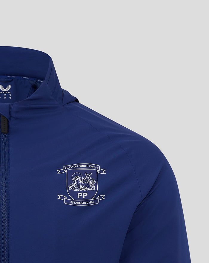 Chest shot of blue training jacket featuring Preston North End FC crest and Castore branding.