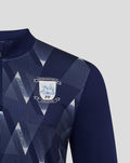 Close up of navy matchday midlayer top showing geometric pattern near shoulder and Preston North End crest