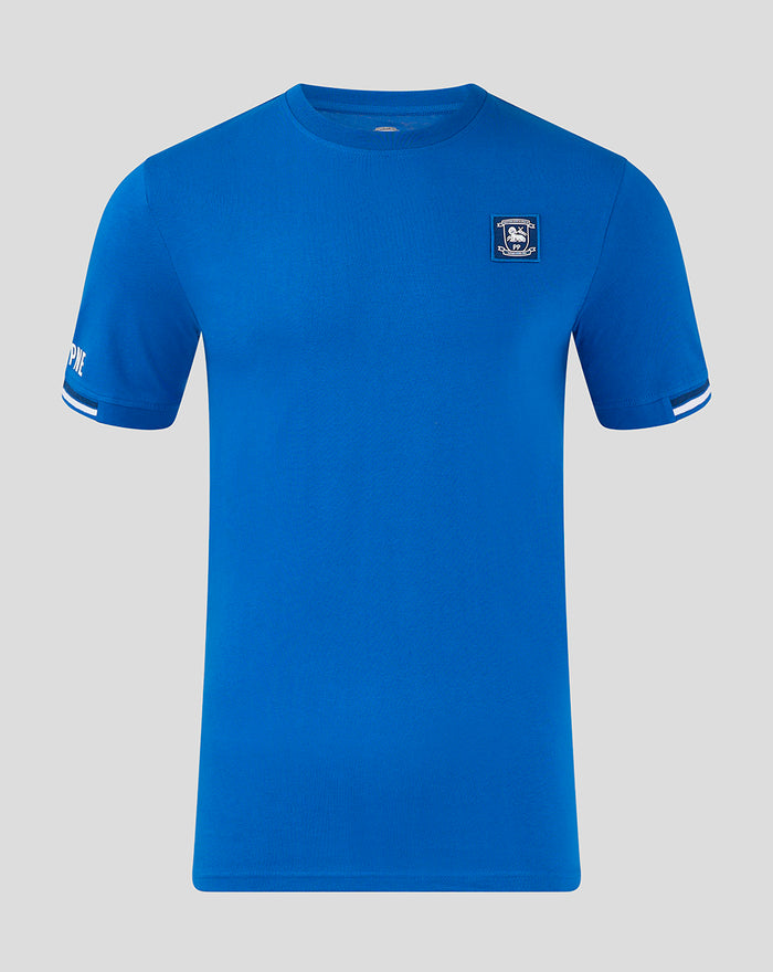 Front view of blue junior Classic Cotton T Shirt with club crest on the left chest and striped cuff detail on the sleeves
