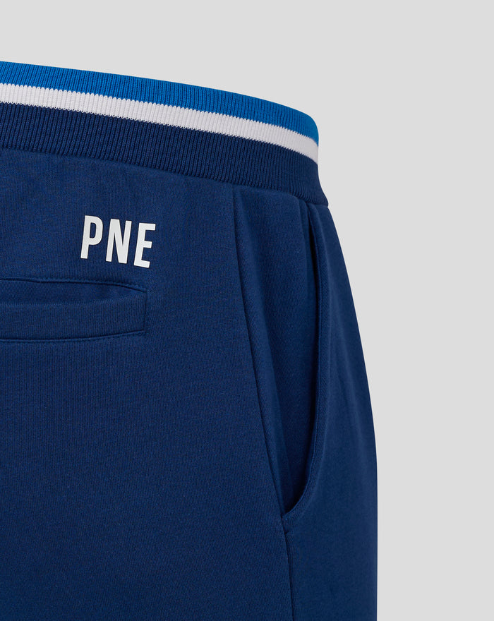 Close-up of navy jogger waistband with blue white stripes and drawcord, featuring a left thigh badge