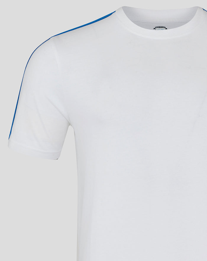 Close up of white men's classic cotton T shirt highlighting blue shoulder piping and a blue crest patch on the chest
