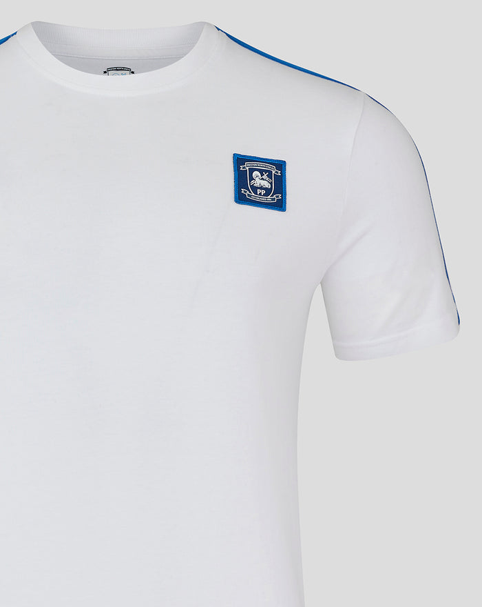 White men's classic cotton T shirt with blue piping along the shoulder and a small blue crest patch on the chest