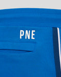 Close-up of blue shorts waistband with PNE lettering and a white side stripe