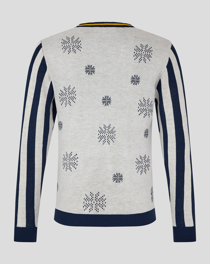 Back view of cream knit Christmas jumper with scattered snowflake motifs and navy striped side panels.