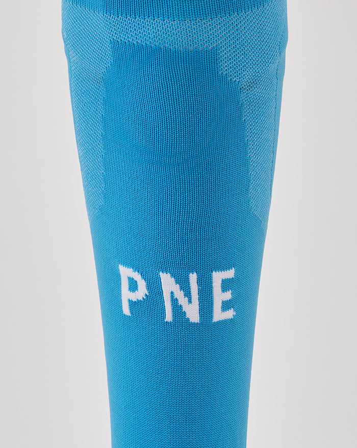 Close-up of blue sock showing white letters PNE on the calf section.
