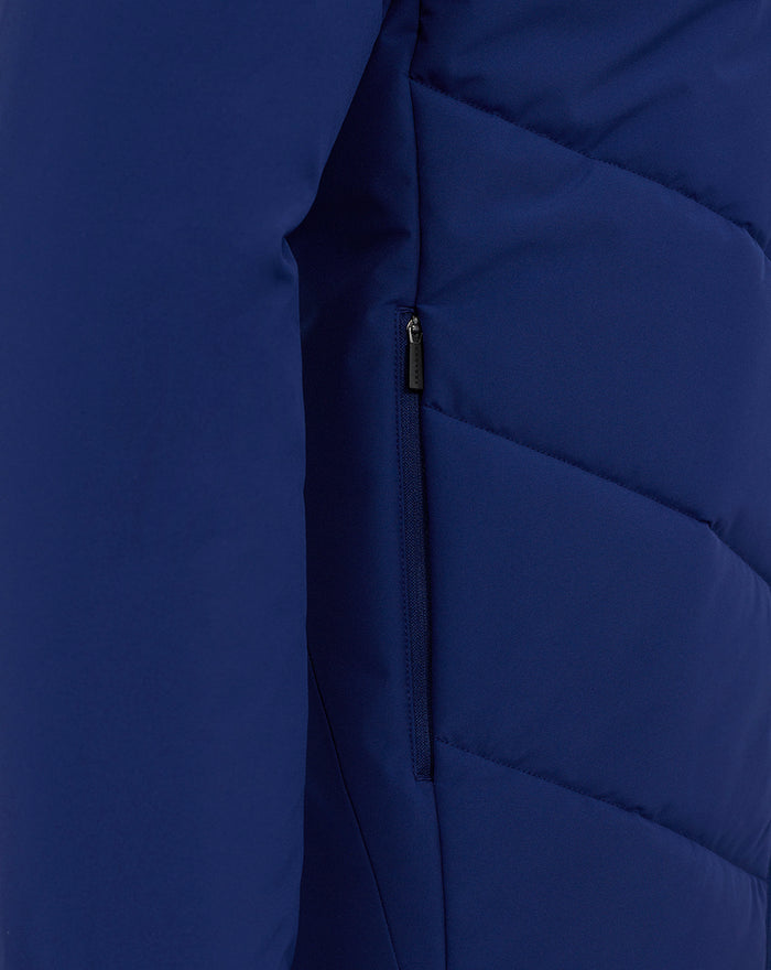 Blue padded training jacket with a vertical zip pocket on the side.