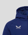Blue junior training padded jacket close up on left chest showing white winged crest and CASTORE text.