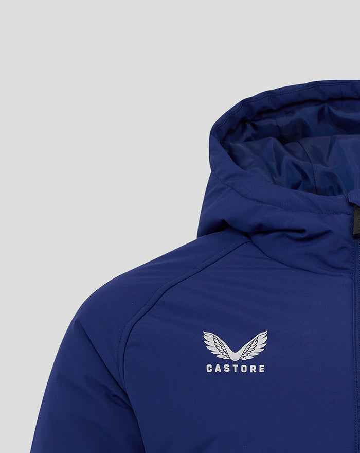 Blue junior training padded jacket close up on left chest showing white winged crest and CASTORE text.