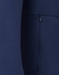 Close up of navy fabric with a zipper pocket on the travel crew sweat