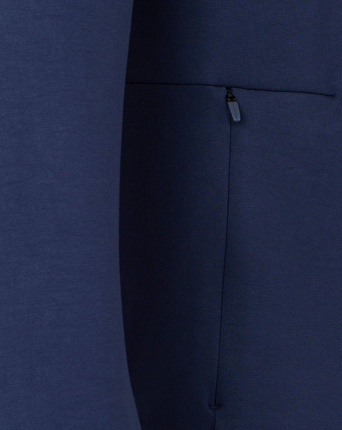 Close up of navy fabric with a zipper pocket on the travel crew sweat