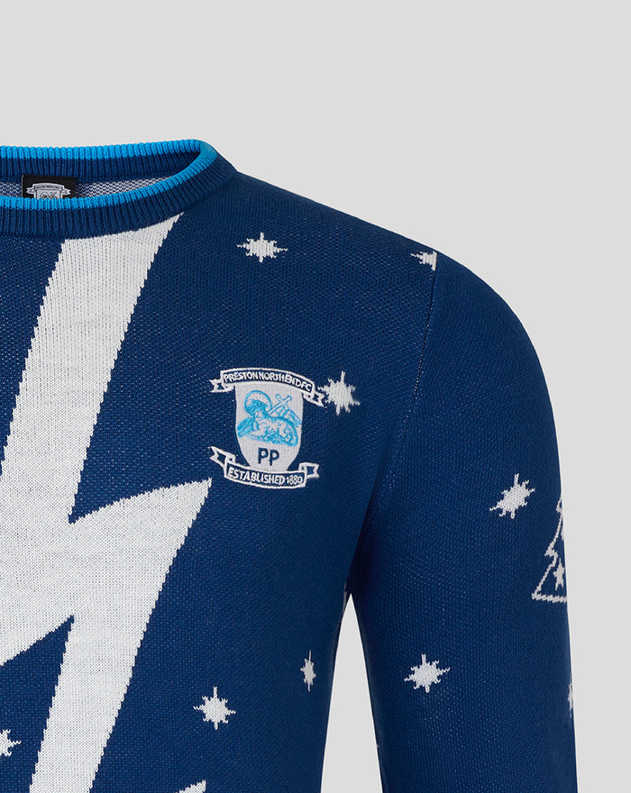 Chest detail of navy Christmas jumper with large white bolt pattern and a crest patch on the left chest.