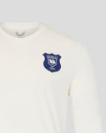 Close up of the navy Wembley crest on the chest of the cream long sleeve shirt.