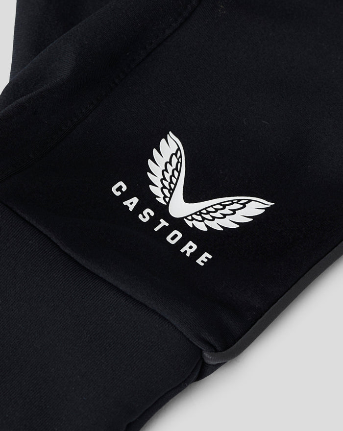 Detail view of black glove fabric with a white wing logo and CASTORE branding.