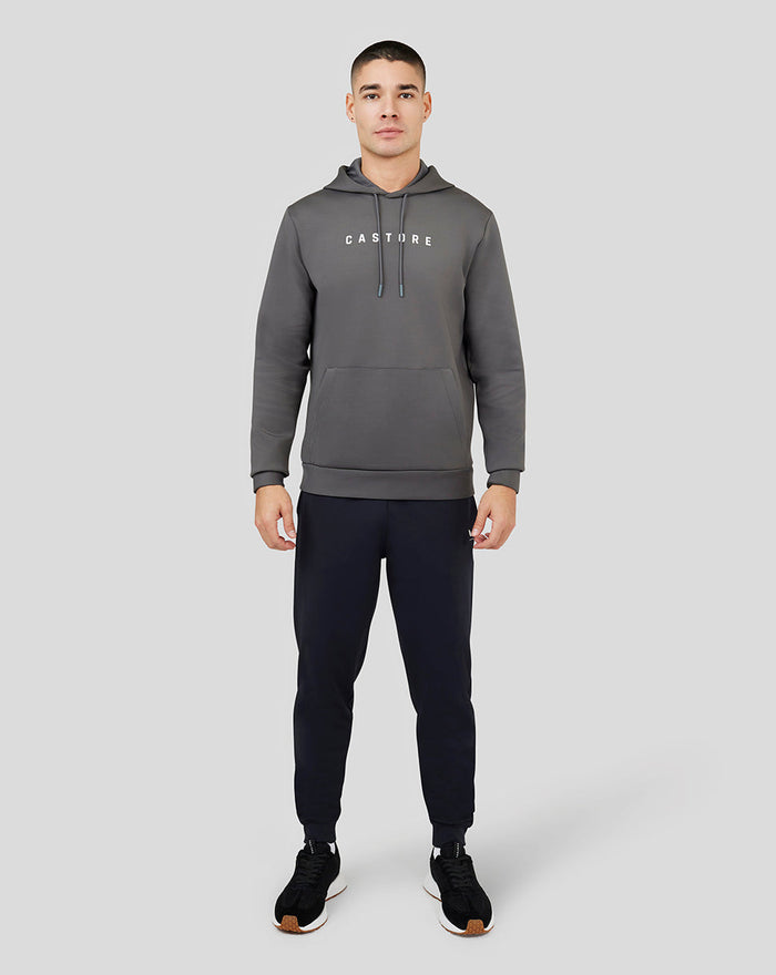 Male model wearing gray Magnet Ore Capsule Scuba Hoodie 3.0 with front pocket and CASTORE logo.
