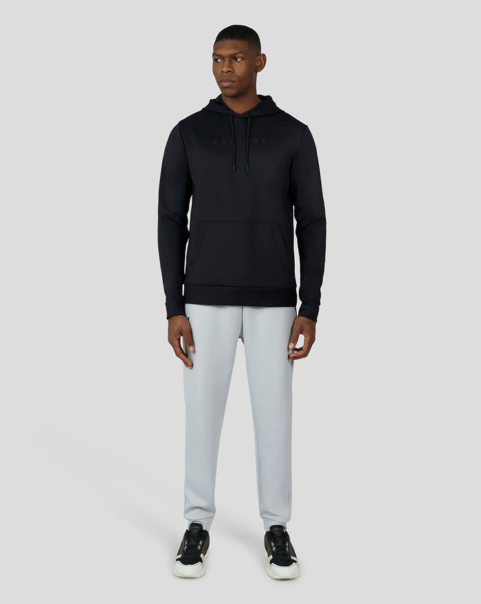 Front view of a model wearing a black Scuba Hoodie 3.0 with hood up and visible logo across chest.