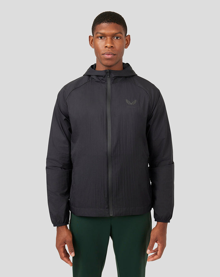 Model wearing Onyx Metatek Flyweight Jacket in dark color with full front zip and subtle reflective branding