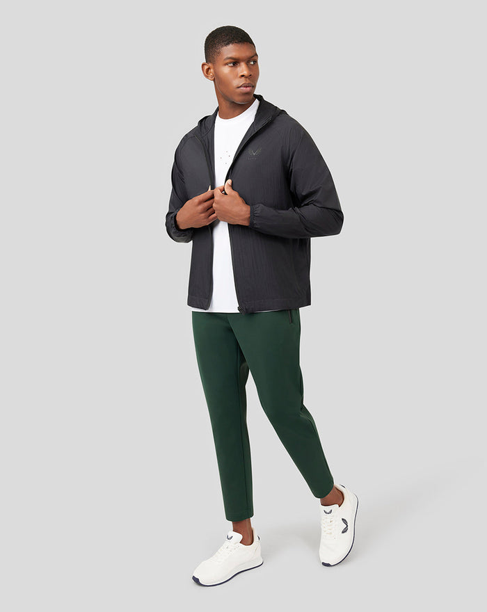 Male model wearing Onyx Metatek Flyweight Jacket in black with hood and front zipper