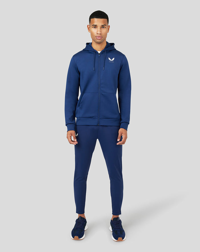Front view of a male model in a blue Peacoat Scuba Zip Through Hoodie showing chest branding and zip closure