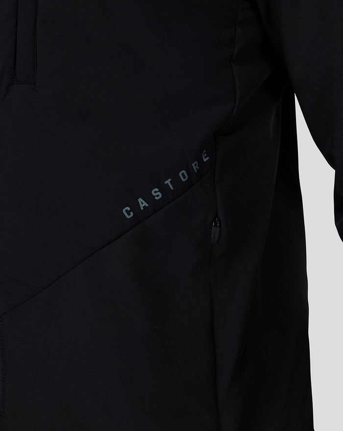 Close-up of black jacket pocket with diagonal seam and CASTORE branding