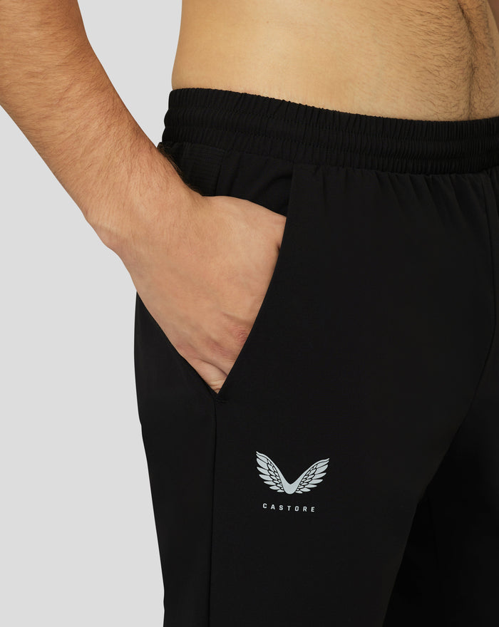 Close up of black Protek woven joggers waistband with drawcord and Castore emblem on the leg