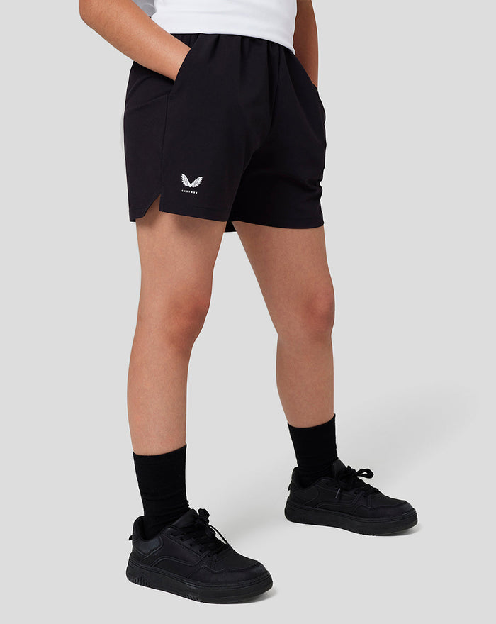 Side view of black Junior Woven Shorts with logo on the front left leg and a small side slit.