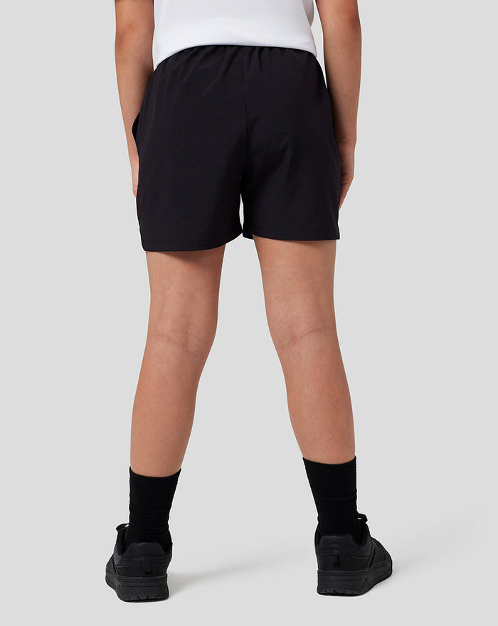 Back view of black Junior Woven Shorts with elasticated waistband and pockets.